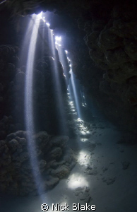Lighting the way. Sun rays at Jackfish alley caves. by Nick Blake 